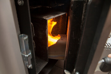 Fire in the pellet stove open door