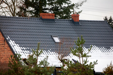 Metal roof of house with snow