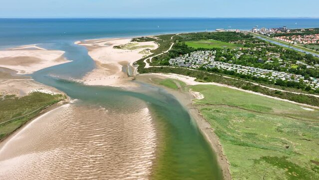Lake and river flowing through green polder landscape at Netherlands and Belgium border, Het Zwin nature reserve