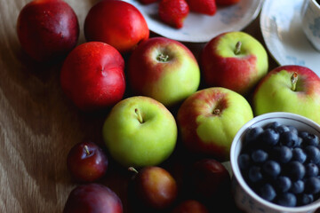 Various healthy seasonal food arranged on wooden background. Selective focus.