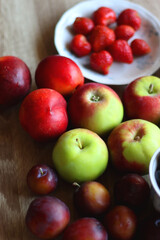 Various healthy seasonal food arranged on wooden background. Selective focus.