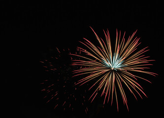 Multicolored fireworks in the dark sky, city day celebration.
