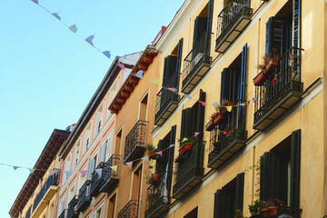 Old facades of vintage buildings downtown in Madrid, Spain. Classical Spanish architecture