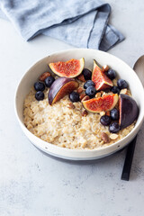 Oatmeal porridge with figs, blueberries, almonds and honey. Healthy eating. Vegetarian food. Breakfast.