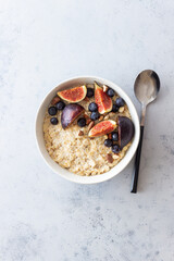 Oatmeal porridge with figs, blueberries, almonds and honey. Healthy eating. Vegetarian food. Breakfast.