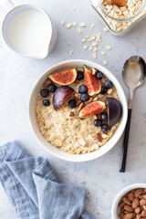 Oatmeal porridge with figs, blueberries, almonds and honey. Healthy eating. Vegetarian food. Breakfast.