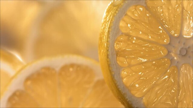 Drop of Lemon Juice flow down the surface of a ripe juicy Lemon slice. Slow Motion 4K