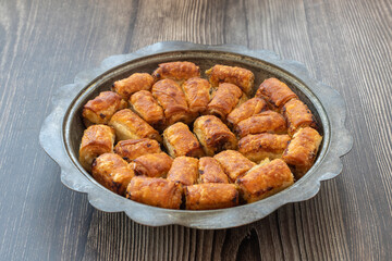 Traditional Bosnian pastry with minced meat (minced meat) in a metal plate. Turkish name; Bosnian dumplings.