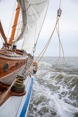 Classic Dutch flatboat goes hard to the wind and makes big waves