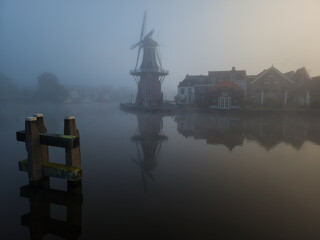 Windmill de Adriaan on a misty morning on the Spaarne River in Haarlem in the Netherlands