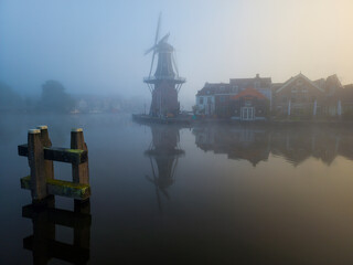 Windmill de Adriaan on a misty morning on the Spaarne River in Haarlem in the Netherlands