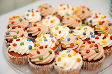Beautiful, colorful cupcake with whipped cream on top
