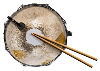 Close-up of two wooden drumsticks and an old metallic snare drum, isolated on white or transparent...