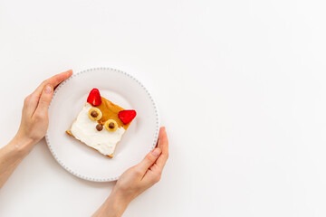 Funny kids sandwich in shape of fox face made from cream cheese and strawberries
