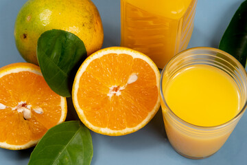 Natural orange juice in the glass with bottle on the side