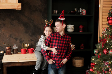 Children give gifts under the Christmas tree