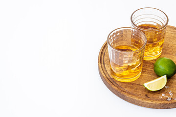 Glass of strong alcoholic drink whiskey with ice. Alcohol background