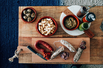 top view of salami with a knife on wood chop board