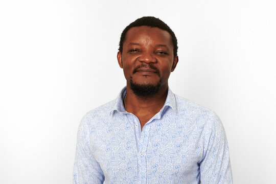 Happy African American Black Man With Small Beard In Casual Bright Shirt Isolated On White Background. Smiling Adult Black Guy Close Up Portrait, Pleasant Excited Candid Male Emotion