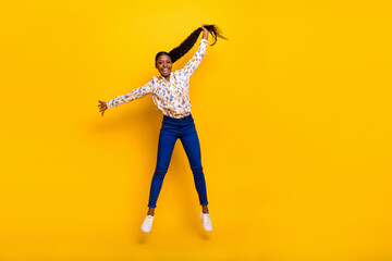 Fototapeta na wymiar Full length body size view of attractive cheerful girly girl jumping holding tail isolated over bright yellow color background