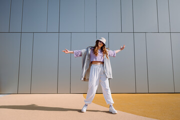 Woman dancerfront of wall. Breakdancing, street dancing, hiphop, freestyle dance.