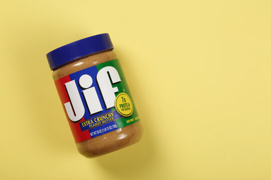 Jif peanut butter jar on a yellow background, top view, flat lay with copy space	