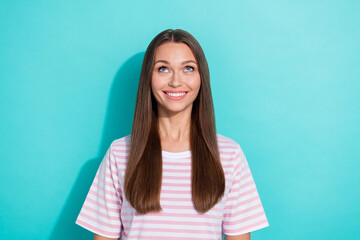 Photo of adorable positive cute girl with straight hairdo dressed striped t-shirt look empty space isolated on turquoise color background