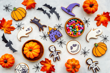 Flat lay pattern of halloween cookies and sweets. Party background