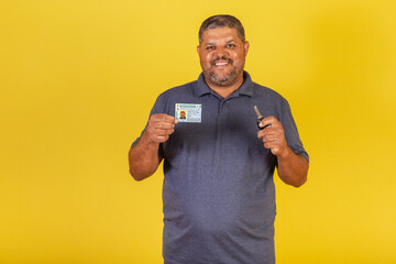Brazilian black male, adult with driver's license, Brazilian document, and car key. - obrazy, fototapety, plakaty