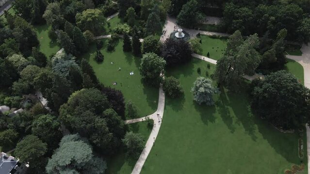 People in Thabor gardens, Rennes in Brittany, France. Aerial top-down forward 