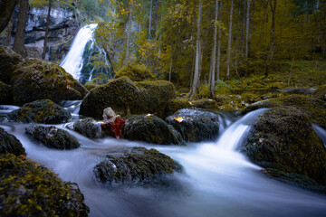 Beautiful fall waterfall with mirrored water
