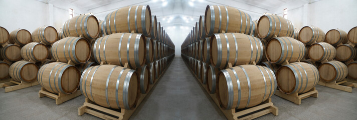 Wine or cognac barrels in the cellar of the winery, Wooden wine barrels in perspective. wine...