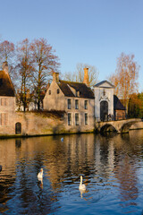 Fototapeta na wymiar Beautiful old town , canals and medieval buildings of Brugge during autumn , winter sunny day : Brugge , Belgium : November 30 , 2019