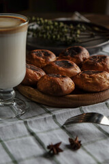 Pastries with coffee and milk in a glass on a white checkered towel