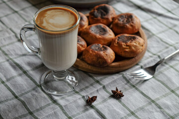 Cake with coffee in a glass on a white checkered towel
