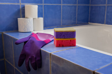 Rubber gloves and sponges inside bathroom