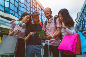 Happy tourists sightseeing with map.