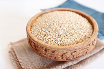 Top view image of quinoa in wooden plate on table
