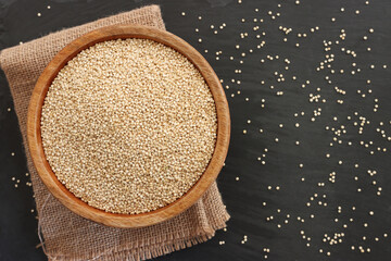 Top view image of quinoa in wooden plate on table