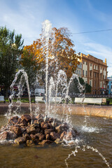 Street fountain on the square in autumn