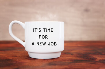 Coffee cup over on wooden table with the text – it's time for a new job