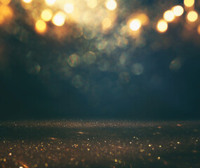 background of abstract glitter lights. gold and black. de focused