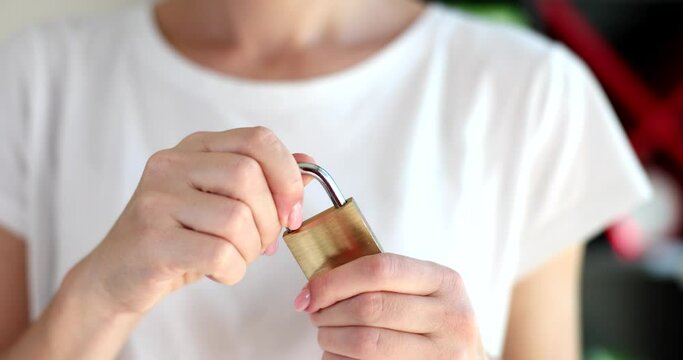 Female hands closing padlock with hands closeup 4k movie slow motion 