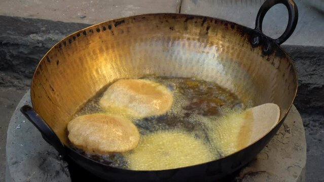 Making of delicious Bengali Luchi (deep fried bread). This is another version of Indian Poori. Indian village vegetarian poodi