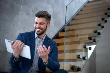 Attractive Businessman using a digital tablet in his office