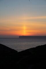 Fototapeta premium mystical sunset by the sea with a section of coast 