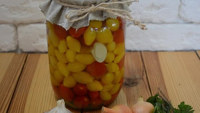Red and yellow tomatoes in a jar