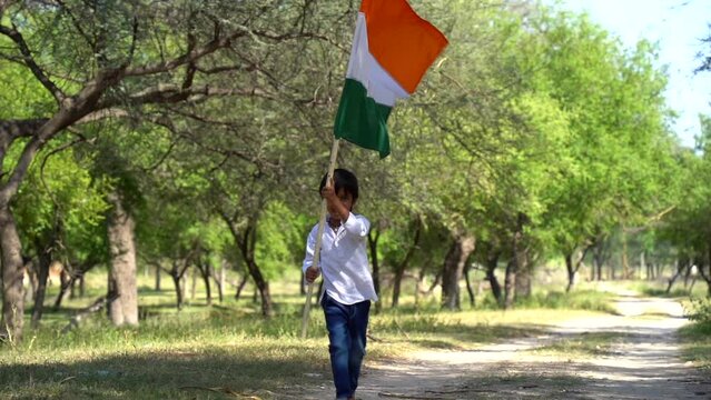Indian child celebrating Independence or Republic day of India. Little boy holding tricolor flag on the occasion of Vijay Diwas