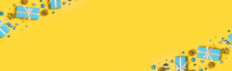 Christmas and New Year greeting banner with gift boxes and decorations on colored background top view, flat lay