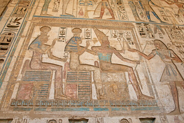 Hieroglyphic carvings on an ancient egyptian temple wall